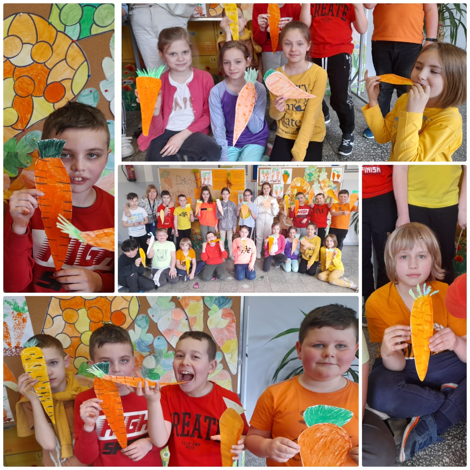 Dzieci pokazują wykonanane przez siebie kartonowe marchewki