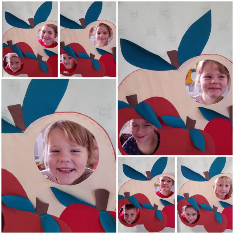 Uśmiechnięte dzieci pozują do zdjęć w fotobudce w kształcie jabłka