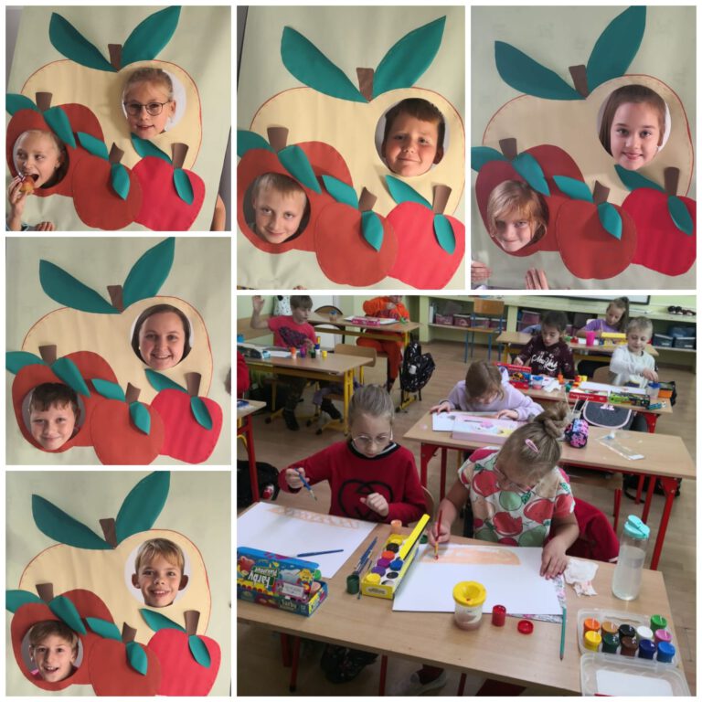 Uśmiechnięte dzieci pozują do zdjęć w fotobudce w kształcie jabłka