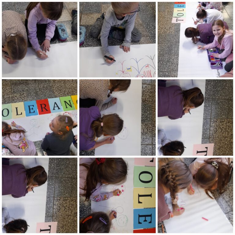 uczniowie na szkolnym korytarzu kolorują i wypełniają rysunkami długi biały pas papieru