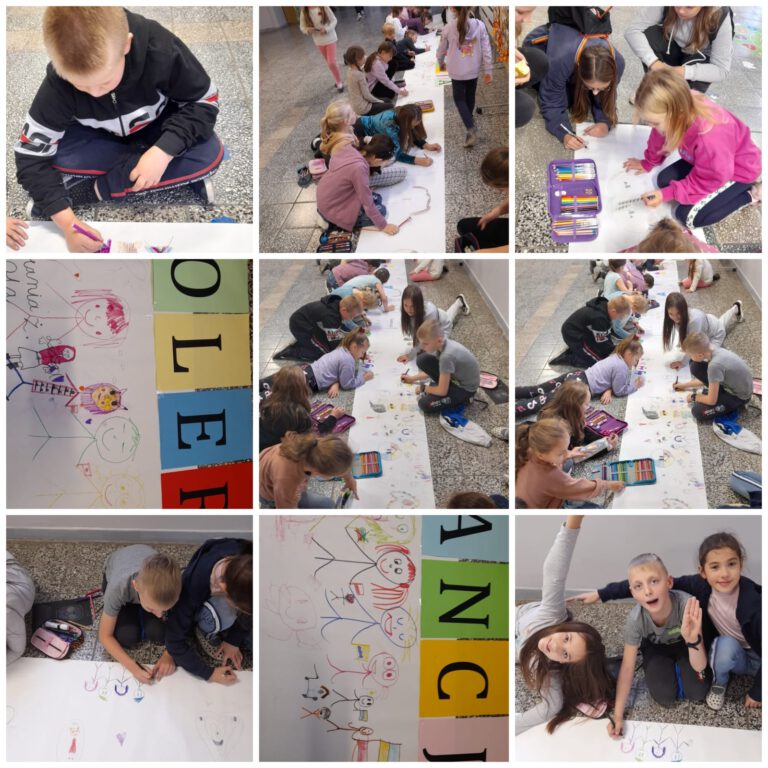 uczniowie na szkolnym korytarzu kolorują i wypełniają rysunkami długi biały pas papieru