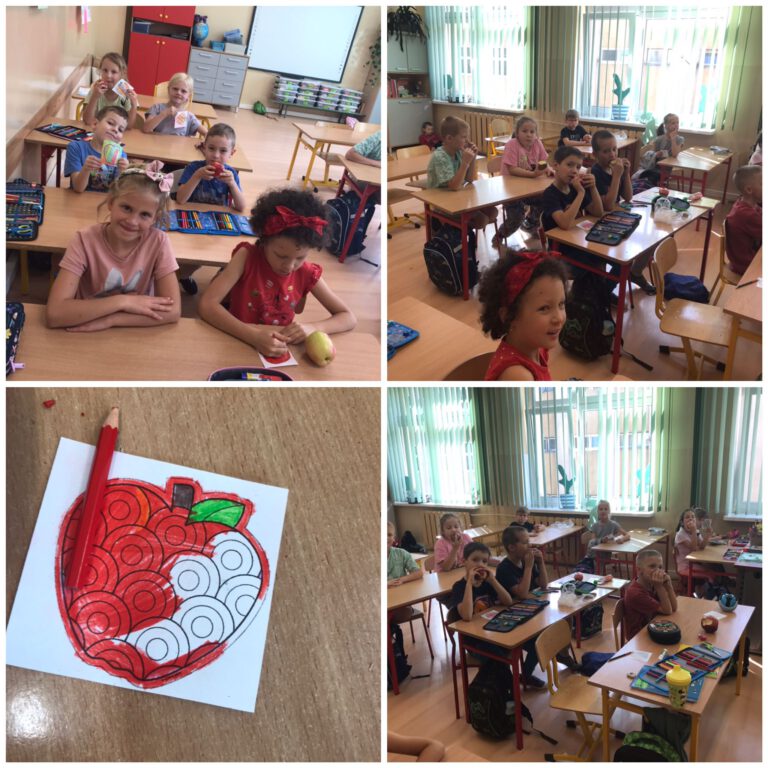 uczniowie w ławkach szkolnych kolorują malowanki motywem jabłka