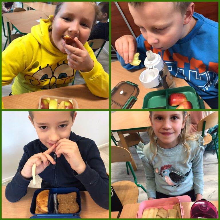 dzieci pokazują swoje śniadaniówki, warzywa, owoce, ciemne pieczywo