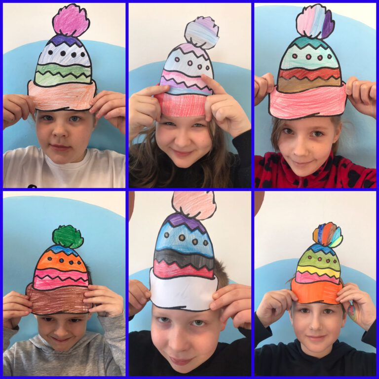 dzieci pokazują papierowe kolorowe czapki zrobione przez siebie