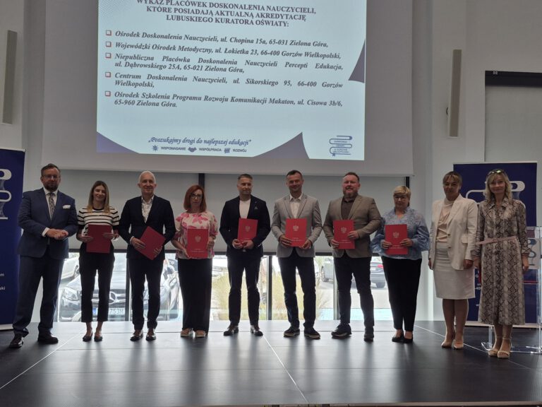 grupa ludzi stoi z na scenie z certyfikatami w rękach